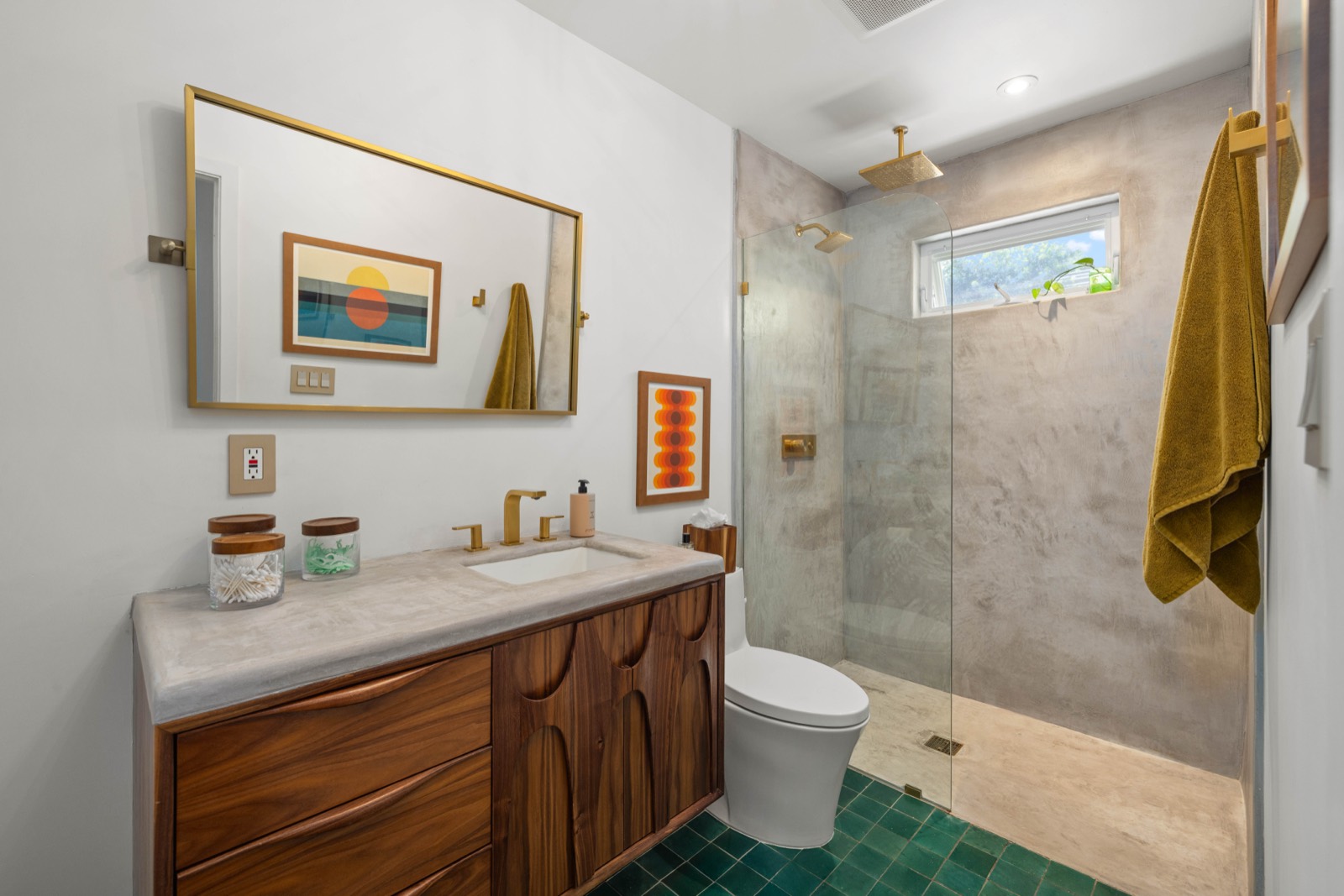 The bath with walnut vanity and concrete shower